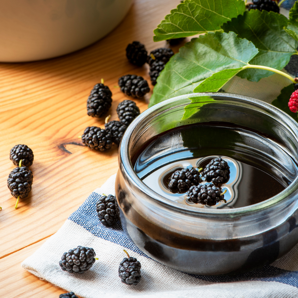 Rich and thick mulberry molasses served in bowl with fresh berries – 300g organic Turkish molasses