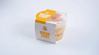 Halva cake with caramel and hazelnut in clear plastic tub, yellow and white packaging